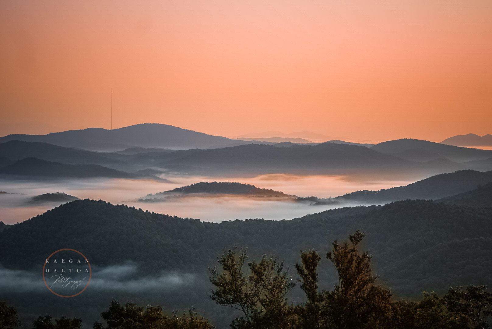 Sunrise over fog-covered mountain ridges in Western North Carolina, photographed by Kaegan Dalton Photography